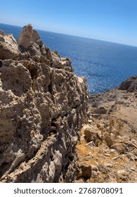 Dramatic Coastal Cliffscape - Eroded Rock Formation Meets Azure Sea