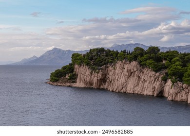 Dramatic coastal landscape of tourist town Makarska, Split-Dalmatia, South Croatia, Europe. Adriatic sea surrounded by majestic Biokovo mountain range. Summer travel destination. St. Peter Forest Park - Powered by Shutterstock