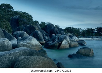 Dramatic coastal seascape with a breathtaking sunset, featuring rocky shores and a serene ocean - Powered by Shutterstock