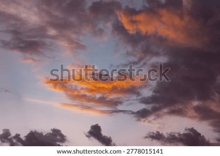 Dramatic colorful clouds in evening sky during vibrant sunset natural background