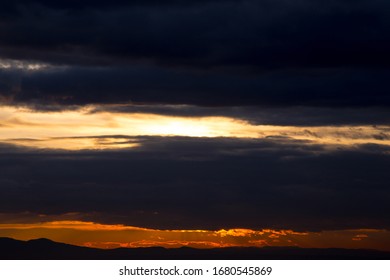 Dramatic colorful sunset with dark clouds landscape