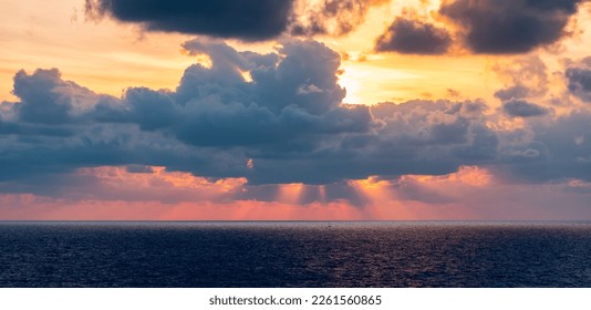 Dramatic Colorful Sunset Sky over Mediterranean Sea. Clouds with Sunrays. Cloudscape Nature Background. - Shutterstock ID 2261560865