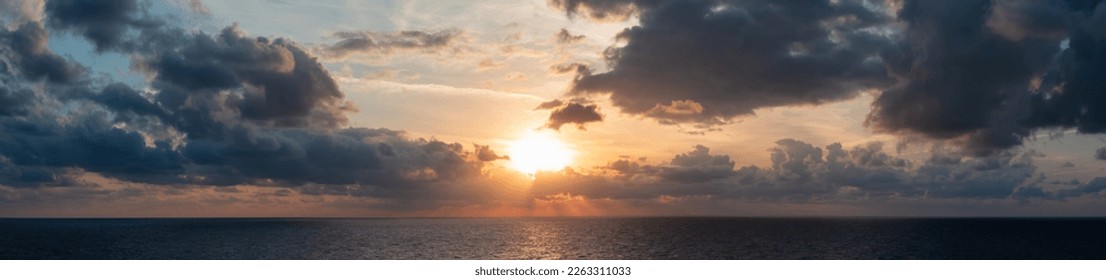 Dramatic Colorful Sunset Sky over Mediterranean Sea. Clouds with Sunrays. Cloudscape Nature Background. Panorama - Shutterstock ID 2263311033