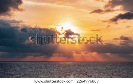 Dramatic Colorful Sunset Sky over Mediterranean Sea. Clouds with Sunrays. Cloudscape Nature Background.