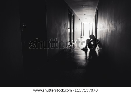 dramatic concept, Silhouette of Sad Depressed man sitting head in hands on the floor.