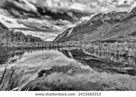 Dramatic contrast black white landscape of mirror lake in Eglinton valley of Fiordland on New Zealand south island.