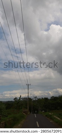 Dramatic Countryside Road Under Stormclouds