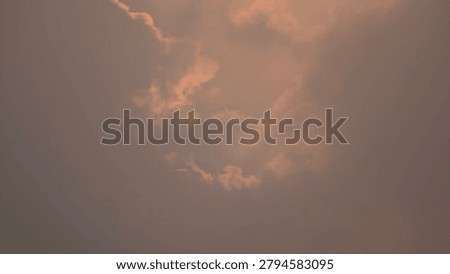 Dramatic crepuscular sun rays breaking through dark storm clouds during sunset or sunrise