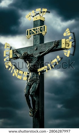 A dramatic crucifix statue against a cloudy sky, featuring golden Hebrew letters and INRI inscription, symbolizing Christian faith.