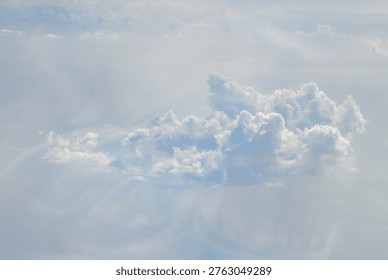 Dramatic cumulus cloud formation against light blue sky with soft atmospheric lighting. Perfect for weather, nature, or wellness-themed commercial projects requiring calming sky imagery.