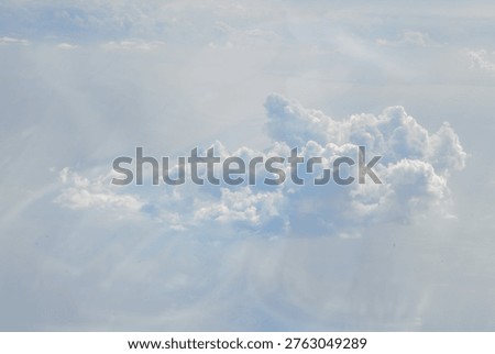 Dramatic cumulus cloud formation against light blue sky with soft atmospheric lighting. Perfect for weather, nature, or wellness-themed commercial projects requiring calming sky imagery.