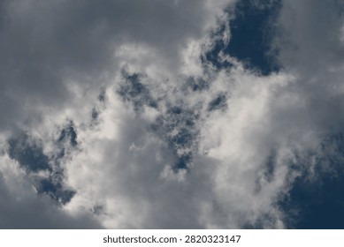 Dramatic cumulus clouds against deep blue sky
