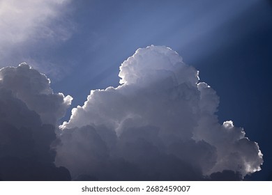 Dramatic Cumulus Clouds with Sun Rays coming out in a Blue Sky – Nature and Weather Background - Powered by Shutterstock - Get 15% off with code: PIKWIZARD15