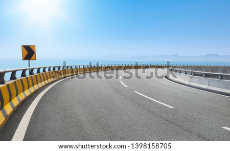 Dramatic curve elevated highway against beautiful blue sky.