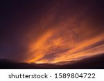 Dramatic dark cloud during sunrise and sunet. Yellow and orange cloudscape. Beautiful abstract background.