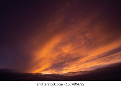 Dramatic dark cloud during sunrise and sunet. Yellow and orange cloudscape. Beautiful abstract background.