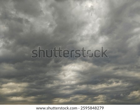 Dramatic dark clouds overcast sky filled with dense clouds.
