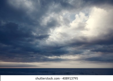 Dramatic dark cloudy sky over sea, natural photo background - Shutterstock ID 408913795