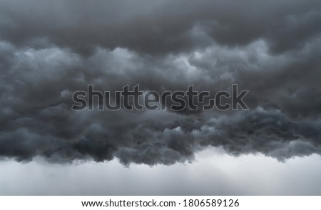 Dramatic dark grey clouds sky with thunder storm and rain. Abstract nature landscape background.