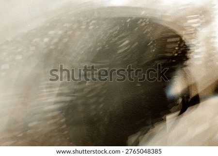 Dramatic dark shadows and light distortions create a mysterious, gritty abstract pattern on a neutral textured wall for creative backgrounds and overlays. Stock photo