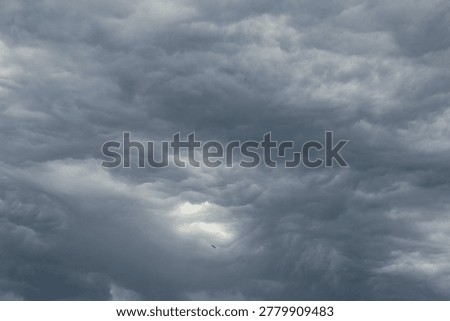 Dramatic dark sky. Heavy gray clouds background photo.