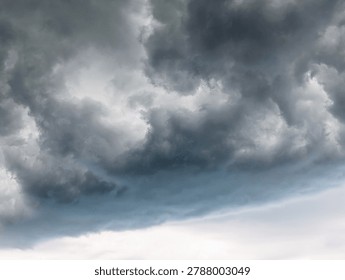 Dramatic dark storm clouds above the horizon. Dark, ominous storm clouds gathering in the sky, creating a dramatic and moody atmosphere before a heavy rain or thunderstorm.