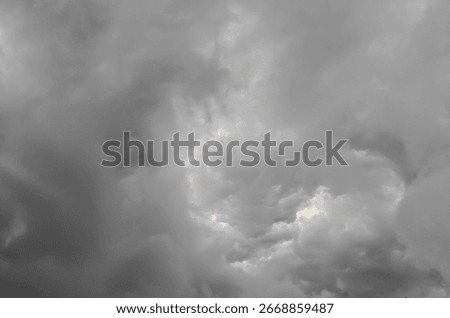 Dramatic dark storm clouds filling the sky, creating a moody and atmospheric weather scene with heavy overcast and natural cloud texture.