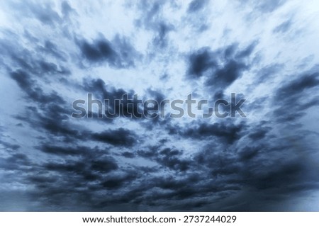 Dramatic dark storm clouds gathering in the sky, ominous atmosphere