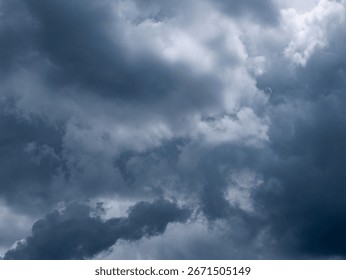 Dramatic dark storm clouds in overcast sky before thunderstorm and heavy rain - moody weather background for climate and meteorology concepts.