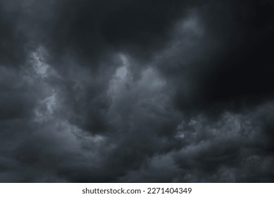 Dramatic dark storm rain clouds black sky background. Dark thunderstorm clouds rainny atmosphere. Meteorology danger windstorm disasters climate. Dark cloudscape storm disaster gloomy gray cloud sky