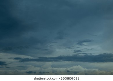 Dramatic dark storm rain clouds black sky background. Dark thunderstorm clouds rainny atmosphere. Meteorology danger windstorm disasters climate. Dark cloudscape storm disaster gloomy gray cloud sky
