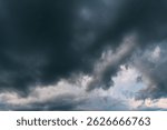 Dramatic dark storm thundercloud rain clouds on black sky background. Dark thunderstorm clouds rainny landscape. Meteorology danger windstorm disaster climate. Dark cloudscape storm disaster gray sky