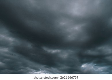 Dramatic dark storm thundercloud rain clouds on black sky background. Dark thunderstorm clouds rainny landscape. Meteorology danger windstorm disaster climate. Dark cloudscape storm disaster gray sky