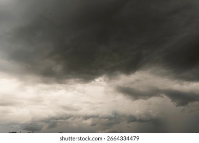 Dramatic dark storm thundercloud rain clouds on black sky background. Dark thunderstorm clouds rainny landscape. Meteorology danger windstorm disaster climate. Dark cloudscape storm disaster gray sky