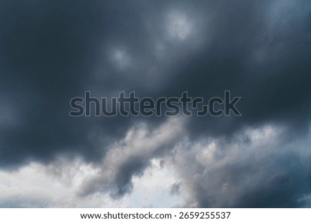 Dramatic dark storm thundercloud rain clouds on black sky background. Dark thunderstorm clouds rainny landscape. Meteorology danger windstorm disaster climate. Dark cloudscape storm disaster gray sky