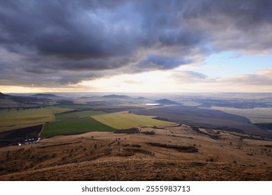 Dramatic dark stormy clouds in sky heaven above Czech Central Mountains landscape far distant view from above, strong wind gale
