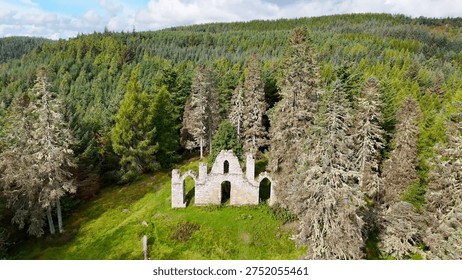 Dramatic Drone Perspective of Creag Ruadh Historical Monument, Secluded Scottish Wilderness Site Surrounded by Ancient Woodland, Fyrish Estate, Ross-shire, United Kingdom.