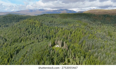 Dramatic Drone Perspective of Creag Ruadh Historical Monument, Secluded Scottish Wilderness Site Surrounded by Ancient Woodland, Fyrish Estate, Ross-shire, United Kingdom.