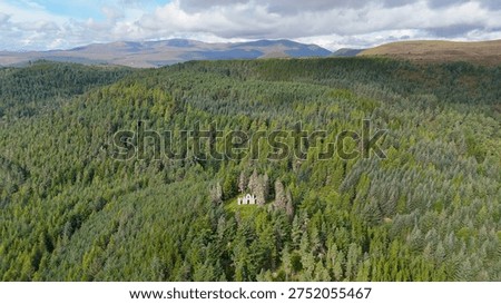 Dramatic Drone Perspective of Creag Ruadh Historical Monument, Secluded Scottish Wilderness Site Surrounded by Ancient Woodland, Fyrish Estate, Ross-shire, United Kingdom.