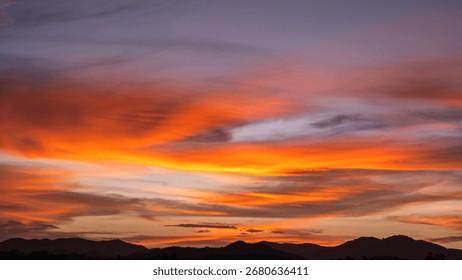 Dramatic Dusk, Evening Sky Clouds on Twilight over mountain horizon landscape Orange, purple Sunset Summer sky Golden Hour sun dawn on nature dark Blue Sky Background