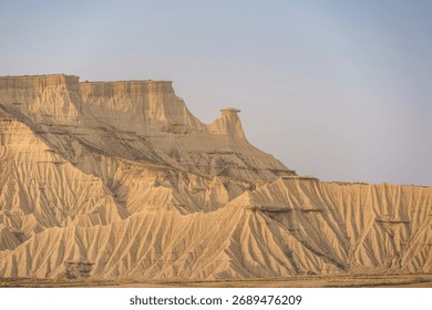 Dramatic eroded badlands with multiple hoodoo formations and layered mesa cliffs in Bardenas Reales desert, Navarra, Spain. Geological landscape for travel
