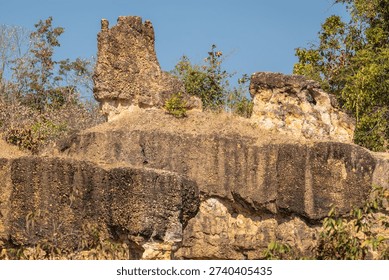 Dramatic eroded earth pillars and rugged canyon landscape define Pai Canyon, Thailand. Sun-drenched natural formations showcase unique geological textures, patterns, and geological marvels, perfect