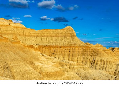 Dramatic eroded rock formations glowing in warm evening light at Badlands National Park, South Dakota