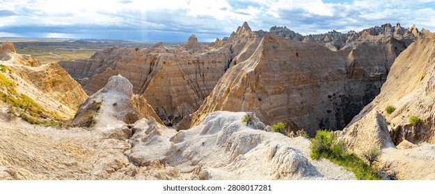 Dramatic eroded rock formations glowing in warm evening light at Badlands National Park, South Dakota