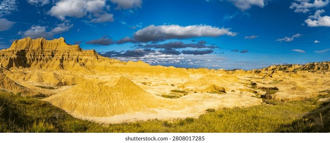 Dramatic eroded rock formations glowing in warm evening light at Badlands National Park, South Dakota