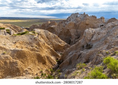 Dramatic eroded rock formations glowing in warm evening light at Badlands National Park, South Dakota