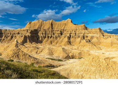 Dramatic eroded rock formations glowing in warm evening light at Badlands National Park, South Dakota