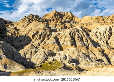 Dramatic eroded rock formations glowing in warm evening light at Badlands National Park, South Dakota