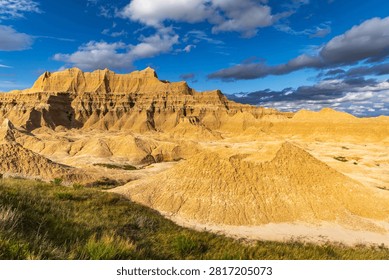 Dramatic eroded rock formations glowing in warm evening light at Badlands National Park, South Dakota