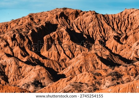 Dramatic erosion pattern and textured sandstone ridge mountain landscape during evening in Skazka Canyon, Kyrgyzstan
